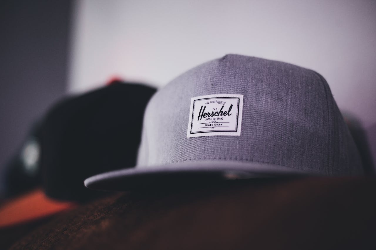 Stylish gray cap with visible trademark label, perfect for casual fashion and branding.